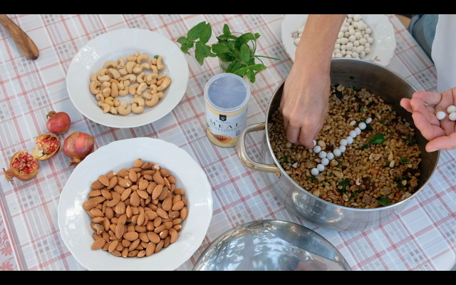 Paula preparing so called ‘Koliva’, a Cretan ritual food, film still 'The Logistics of Paradise', (c) Paula Hildebrandt